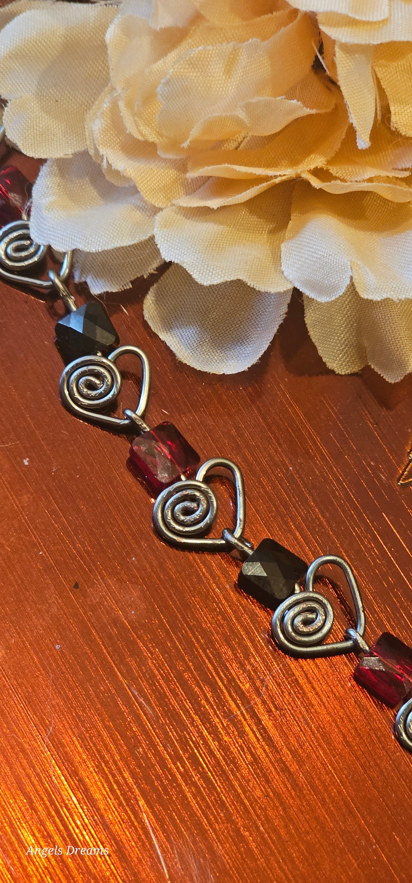 Hematite heart chain with red and black swarovski square crystals.